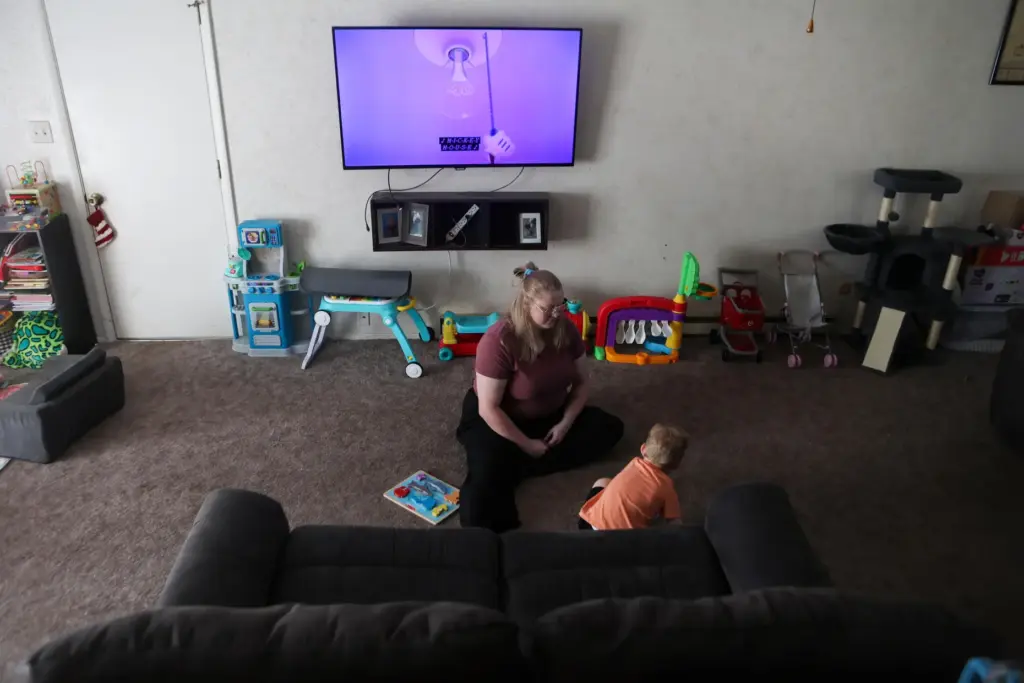 Meygan Maloney does a Mickey Mouse puzzle with her son...