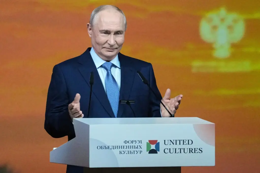 Russian President Vladimir Putin gestures as he speaks at an...