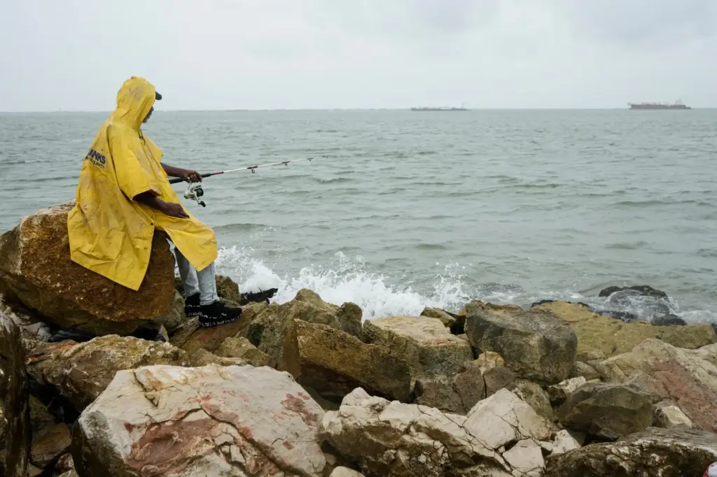 A fisherman who goes by the name “Jellybean” casts his...