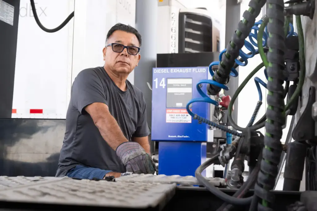 Truck driver Carlos Quintanilla refuels his diesel truck at SC...