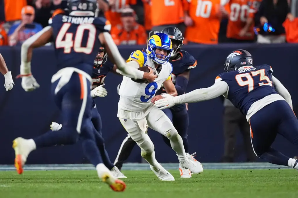 Rams quarterback Matthew Stafford (9) scrambles for yardage against the...