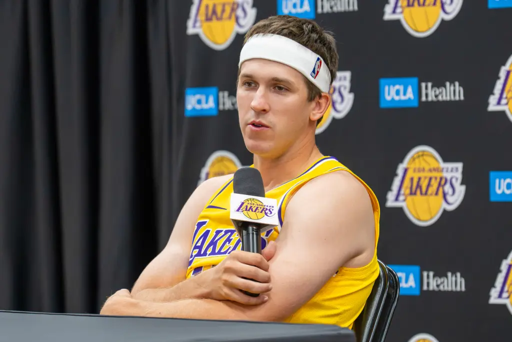 Lakers guard Austin Reaves listens to questions from reporters during...