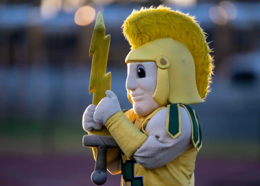 The Edison High School Chargersâ mascot greets players as they...