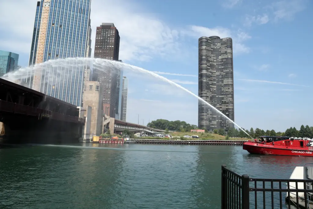 A Chicago Fire Department boat pumps water onto the DuSable...