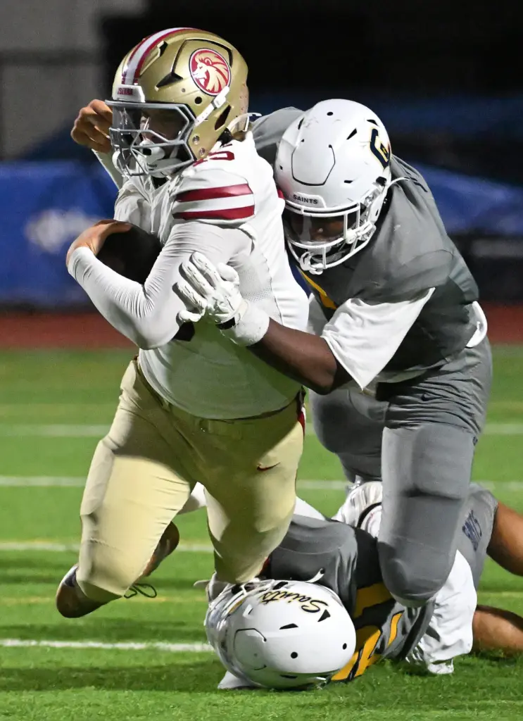 JSerraâs Wyatt McKinney (45) holds onto the ball as Crean...