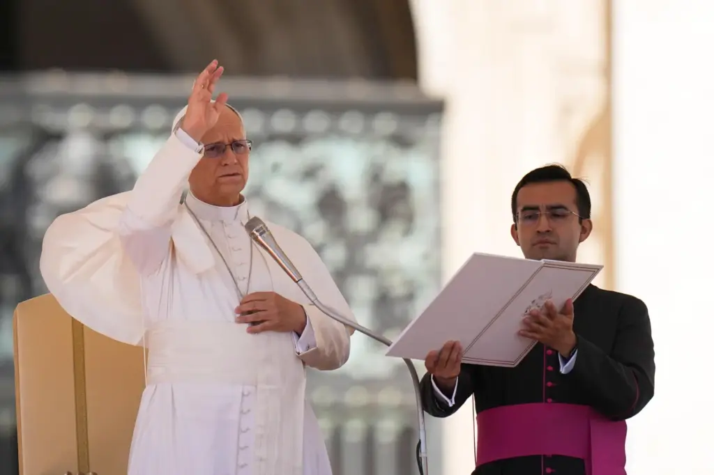 Pope Leo XIV, flanked by his private secretary, Edgard Ivan Rimaycuna Inga, delivers his blessing.