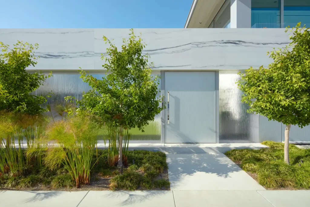 The front gate is set into a wall of gray-veined...