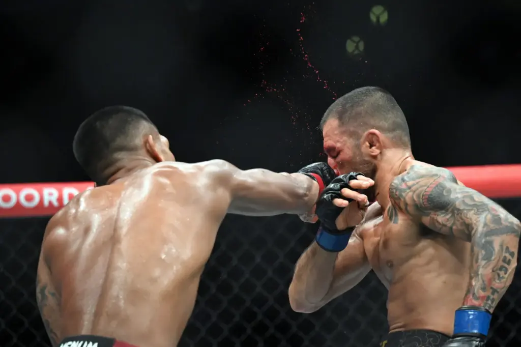 Flyweight champion Joshua Van (red) lands a punch on Alexandre...