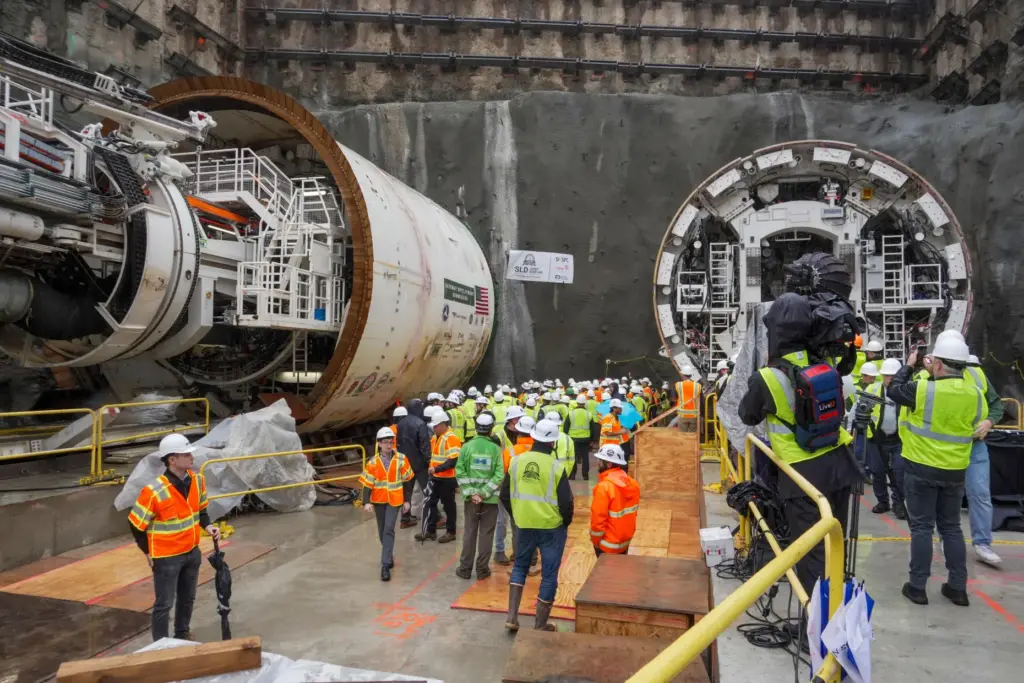 Officials gather between two tunnel-boring machines in North Bergen, N.J.,...