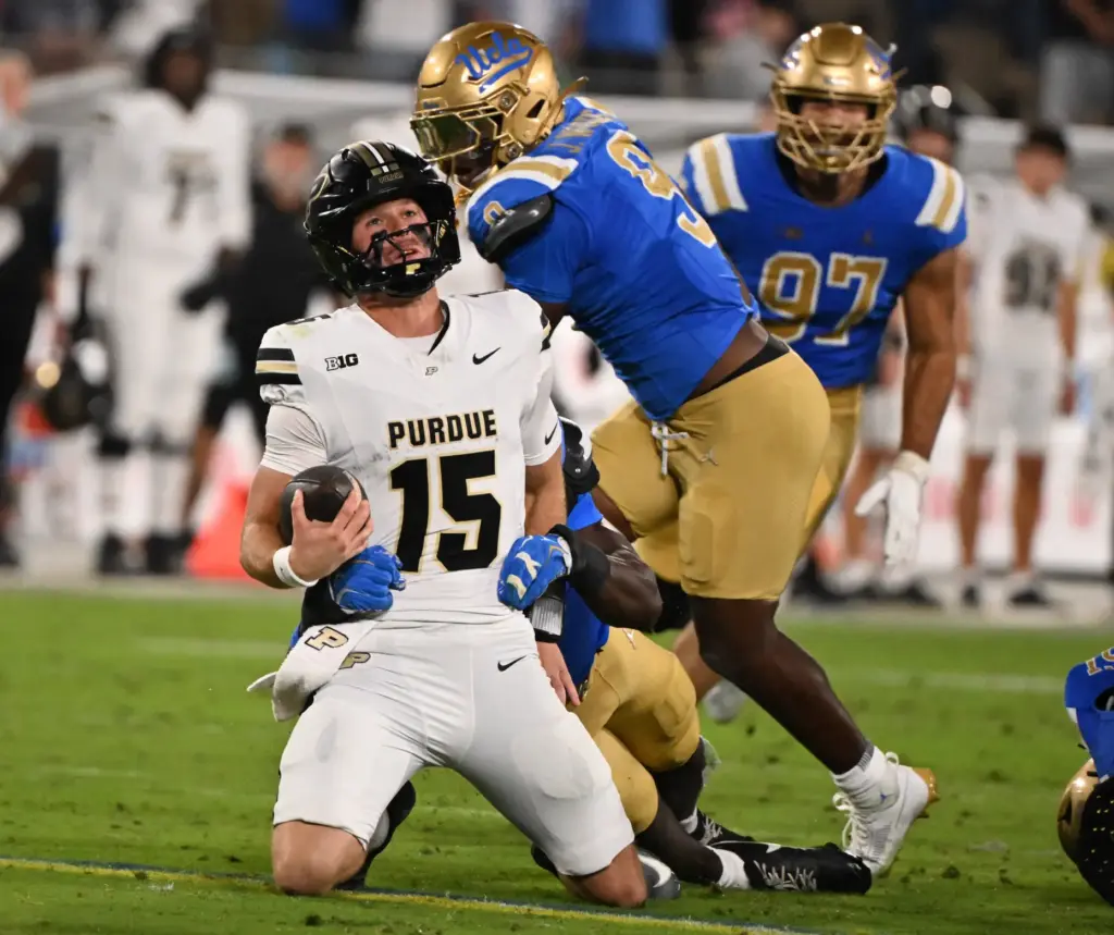Linebacker Sammy Omosigho (10) of the UCLA Bruins sacks quarterback...