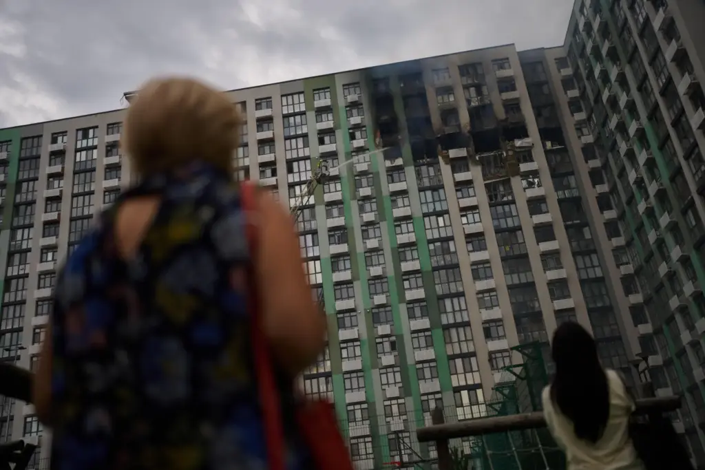Firefighters work after a Russian drone attack struck a residential building in Kyiv.