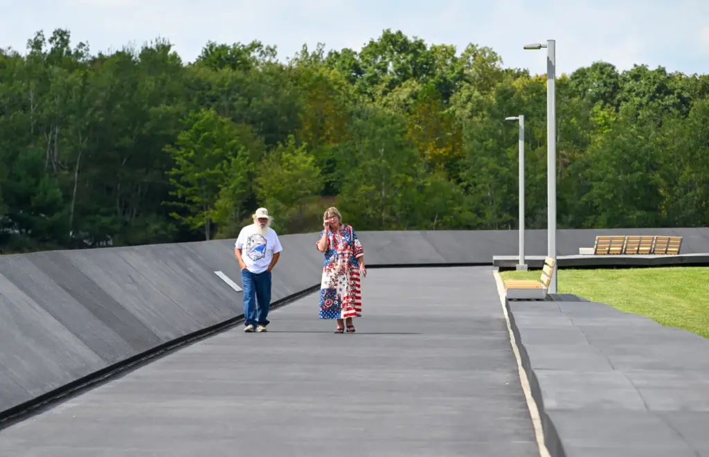 Geri Johnson and her brother-in-law, Terry Johnson, walk along the...