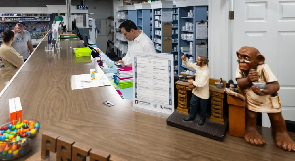 Customers wait at the pharmacy at Bushardâs Pharmacy in Laguna...