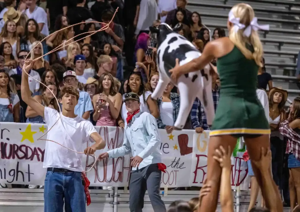 An Edison student tries to lasso an inflatable cow being...