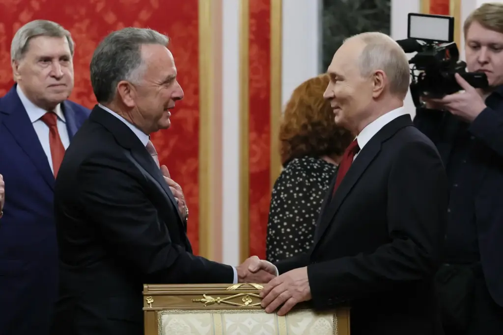 President Vladimir Putin, right, greets U.S. President Donald Trump’s envoy...