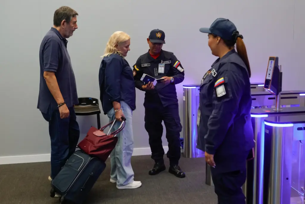 Departing passengers stand at security inside Simon Bolivar International Airport...