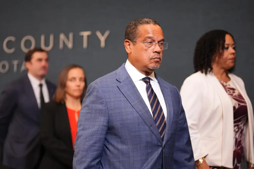 Minnesota Attorney General Keith Ellison leaves after a news conference.