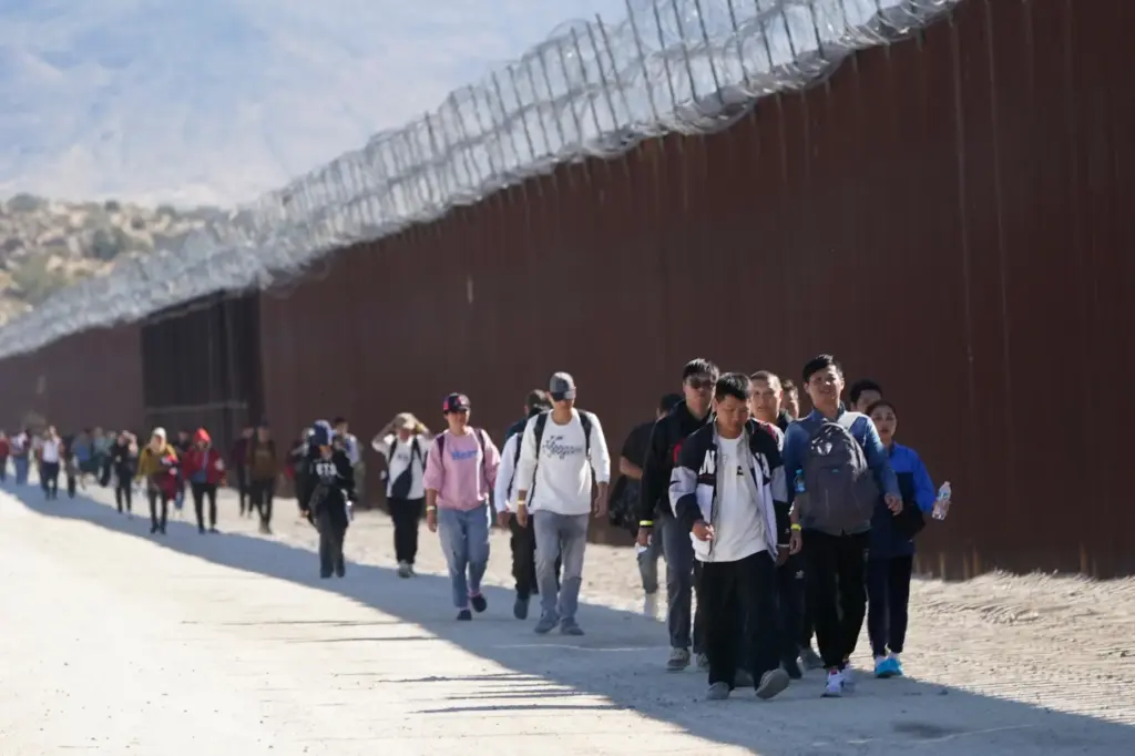FILE – A group of people, including many from China,...