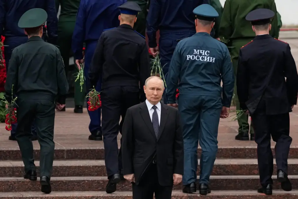 FILE – Russian President Vladimir Putin attends a wreath-laying ceremony...