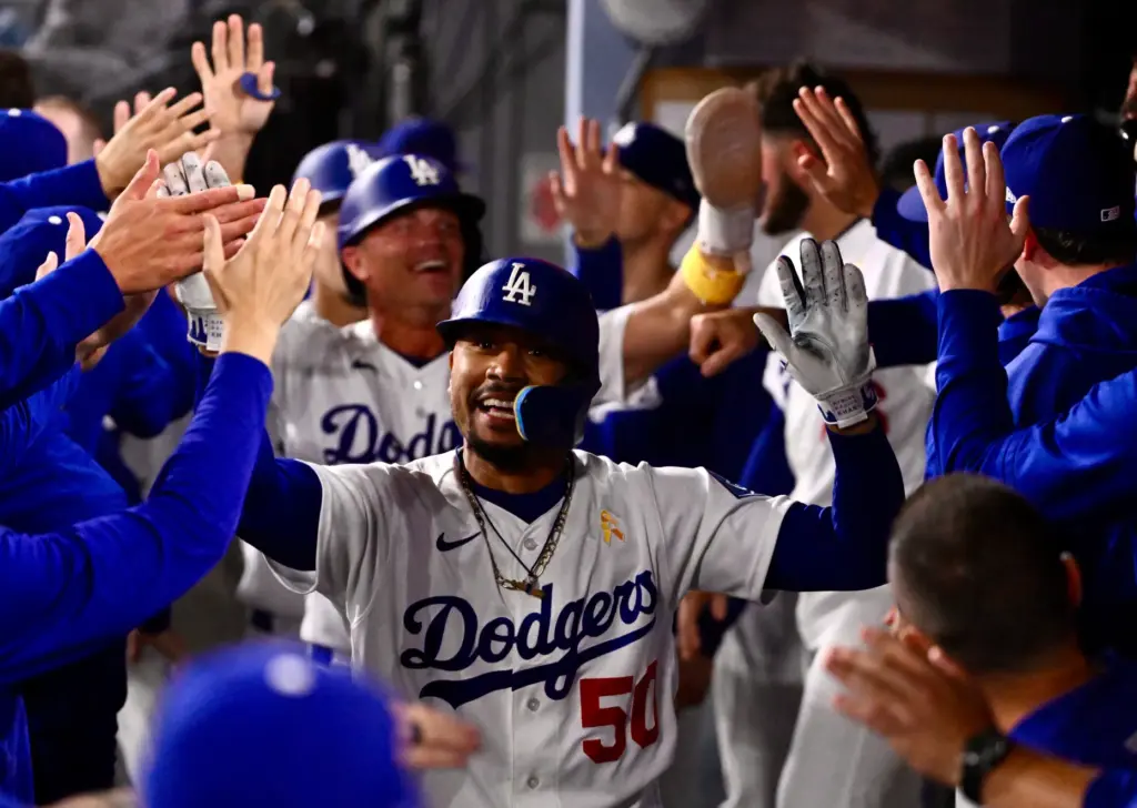 Dodgers shortstop Mookie Betts celebrates with his teammates after hitting...