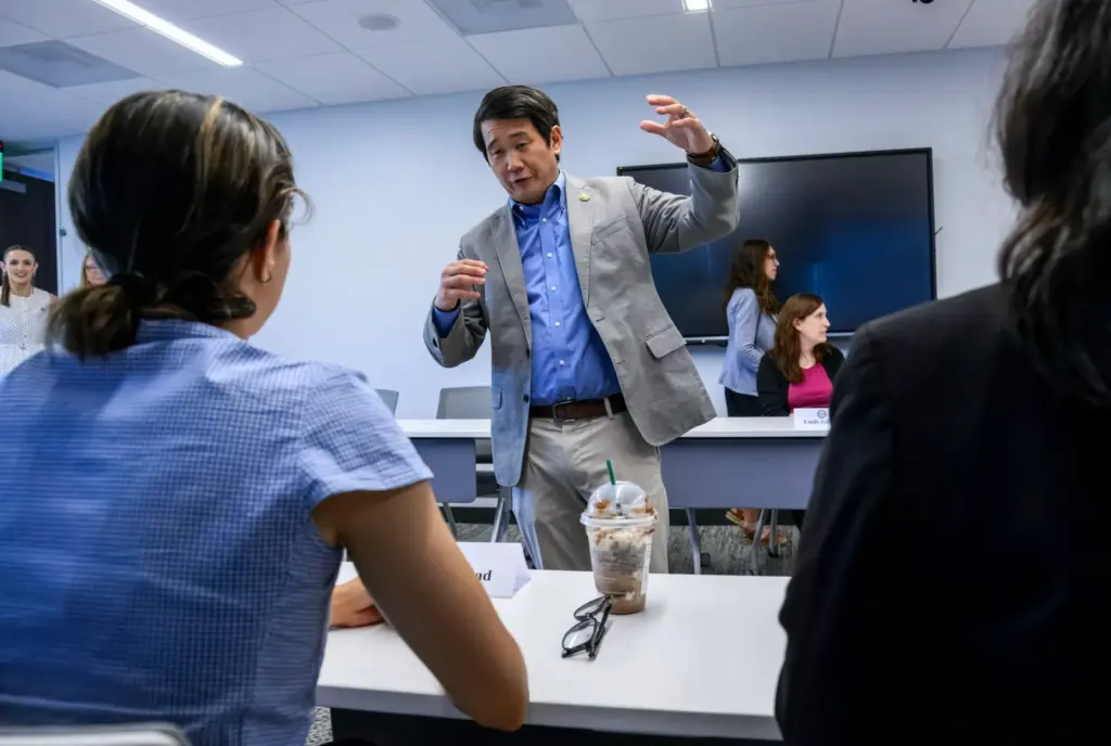 Congressman Dave Min of the 47th Congressional District talks with...