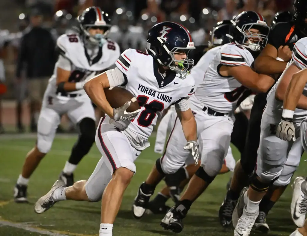 Yorba Lindaâs Maddex Schroeder (18) takes the ball down the...