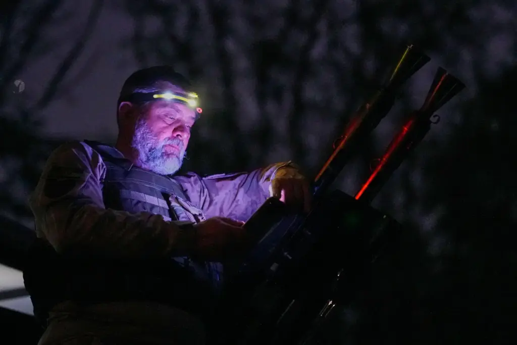 A Ukrainian air defense soldier gets ready to repel Russia’s...