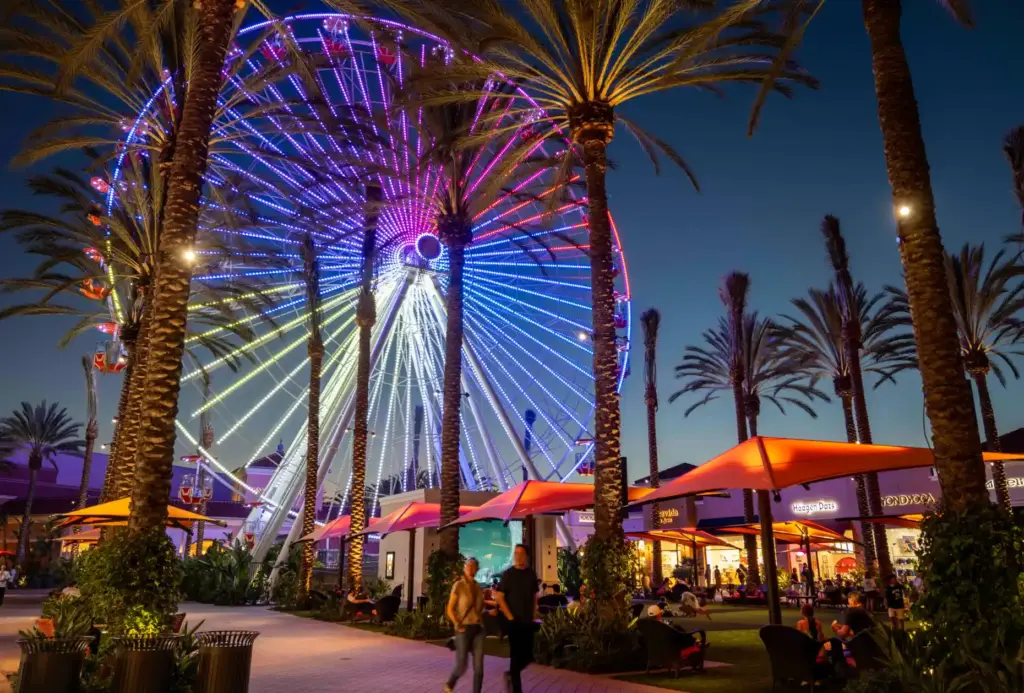 Irvine Spectrum visitors walk through the Central Court while others...
