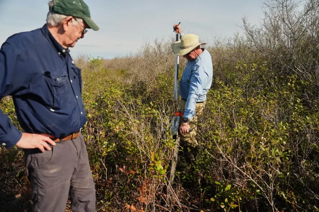 Neal Flanagan, right, a research scientist at Duke University, uses...