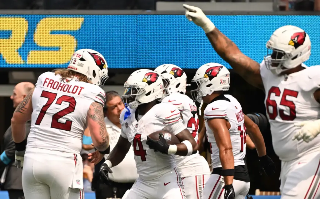 Arizona Cardinals running back Jeremiyah Love (4) reacts after scoring...