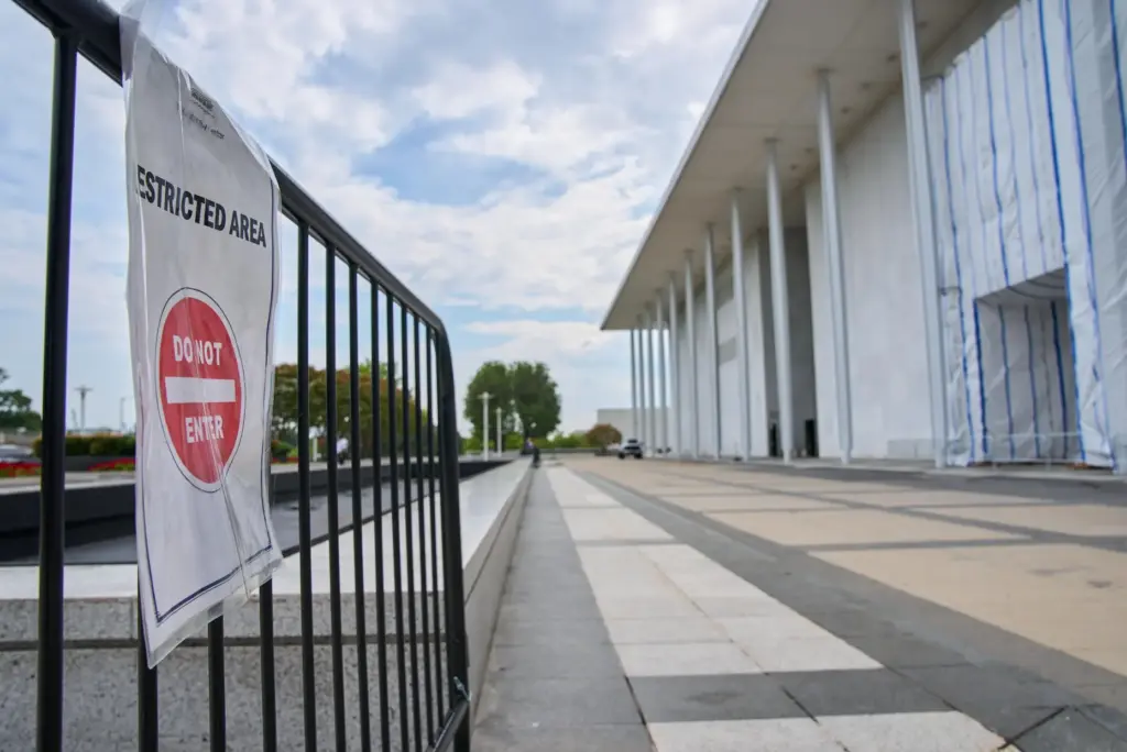 A sign directs people away from the Kennedy Center, which...