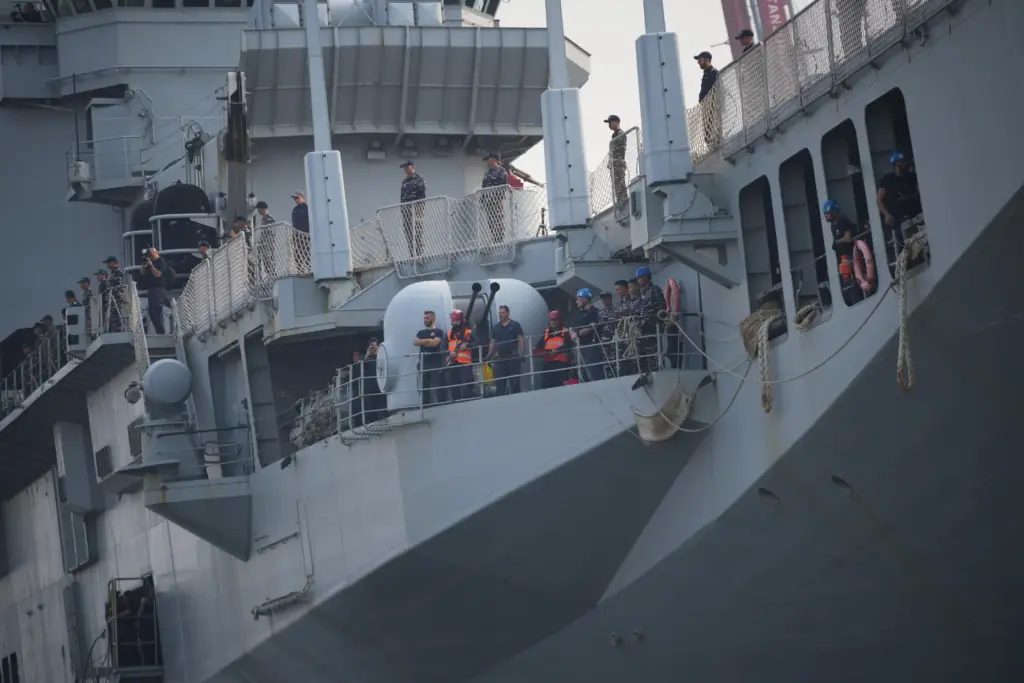 Indonesian Navy personnel and crew members stand aboard the Giuseppe...