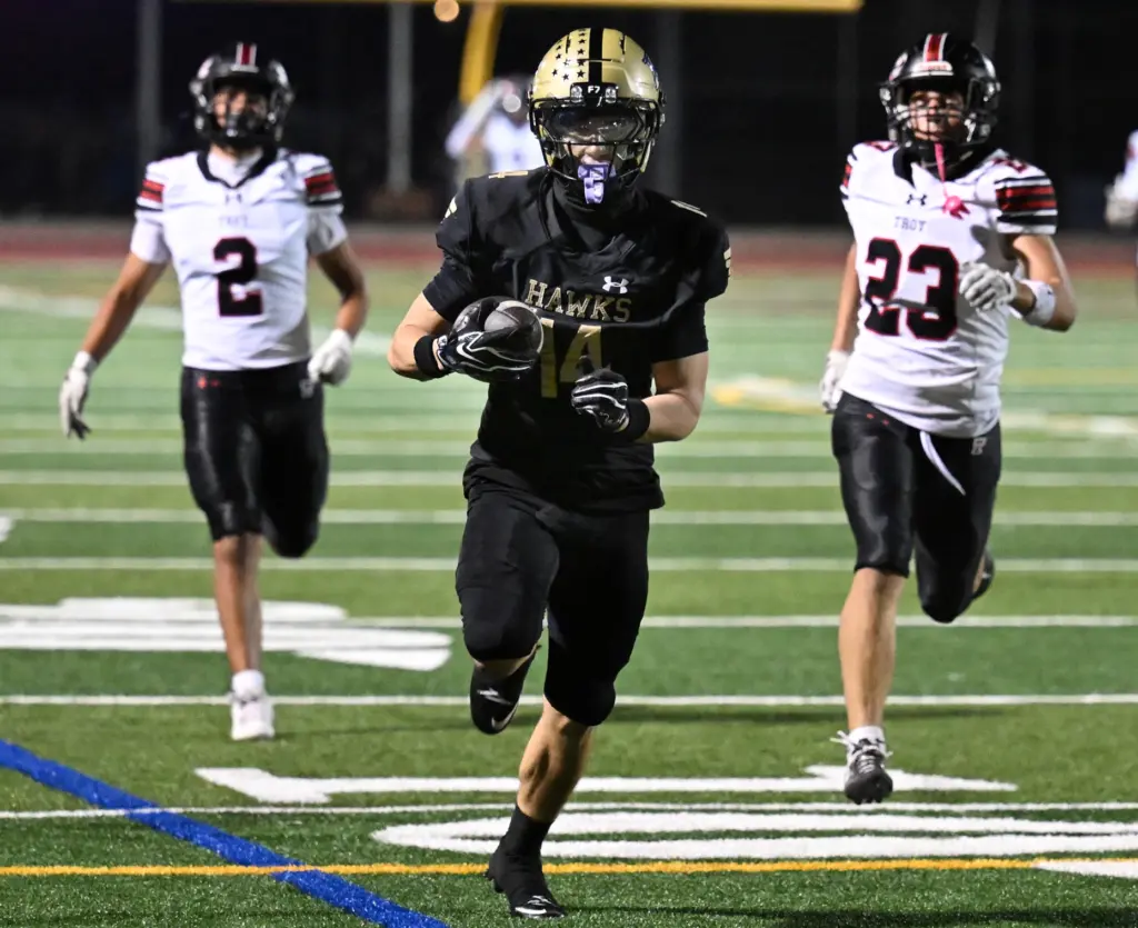 Mason Shackleton #14 of El Dorado runs for a touchdown...