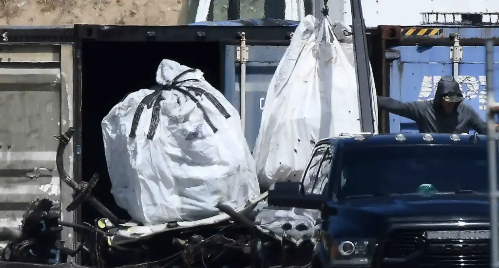 Salvage crews help NTSB investigators remove of whatâs left of...