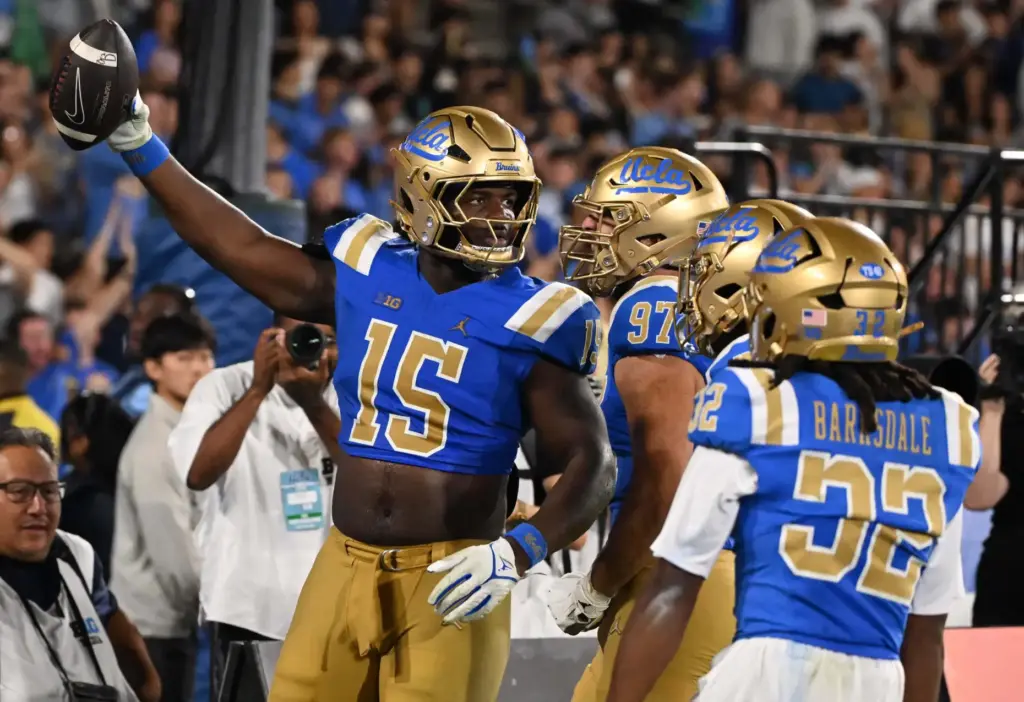 Defensive lineman Sahir West (15) of the UCLA Bruins recovers...