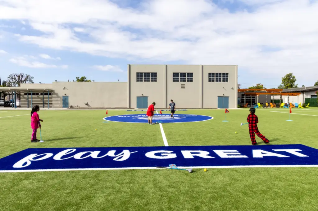 Children practice their golf skills after school on the new...