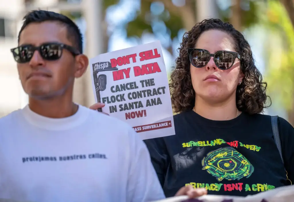 Privacy advocates hold signs during a press conference for the...