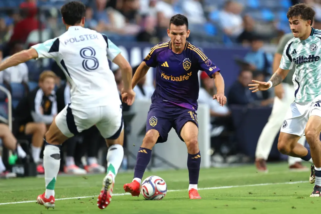 Galaxy forward Hirving Lozano, center, controls the ball against the...