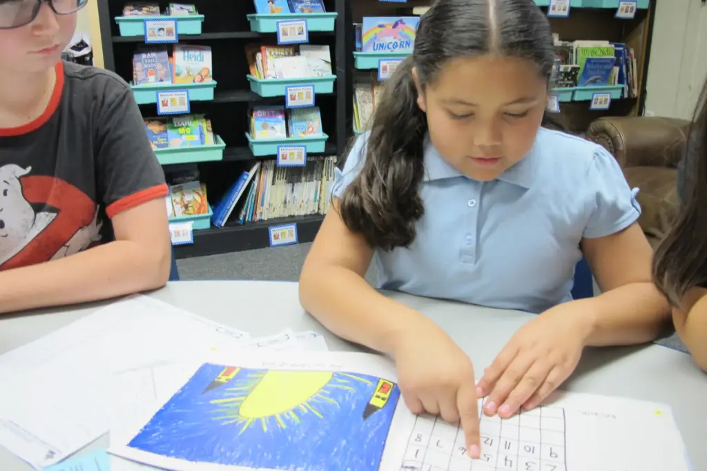 Orangethorpe Elementary School fifth-grader Mia Valencia reads to her classmates...