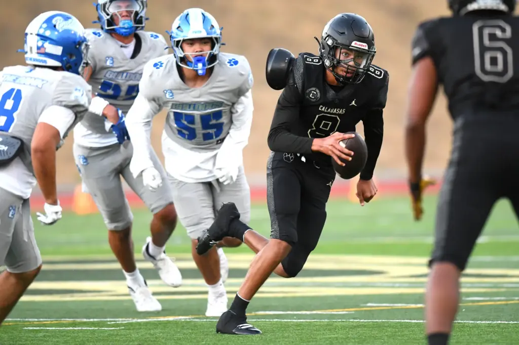 Calabasas quarterback Dominik Hardy scrambles to avoid being sacked by...