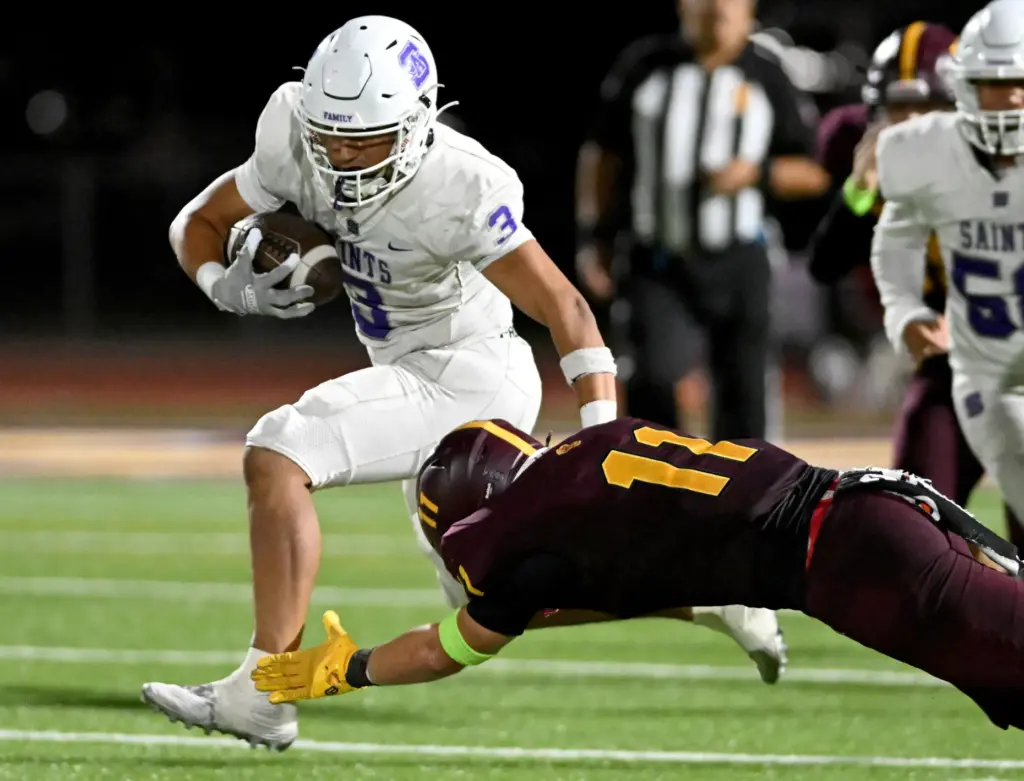 St. Anthony Saints Evan Martinez (3) avoids a tackle by...