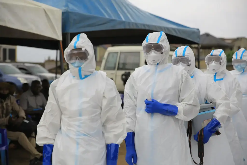 Ebola response teams organize a public demonstration to raise awareness...