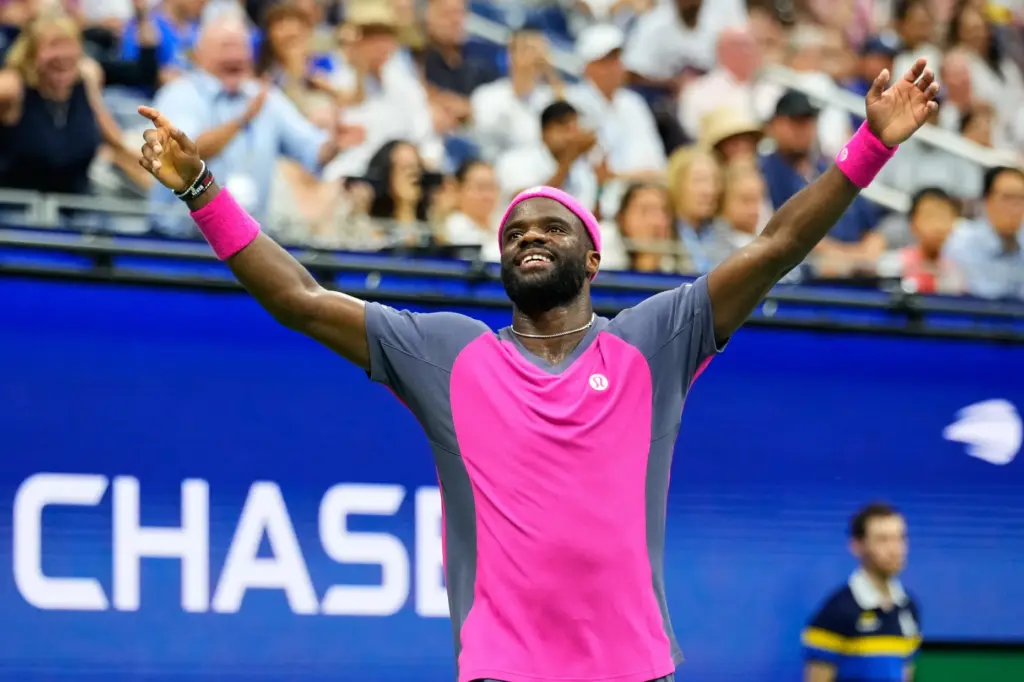 Frances Tiafoe celebrates after erasing a two-set deficit to defeat...