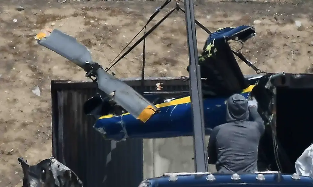 Salvage crews help NTSB investigators remove of whatâs left of...