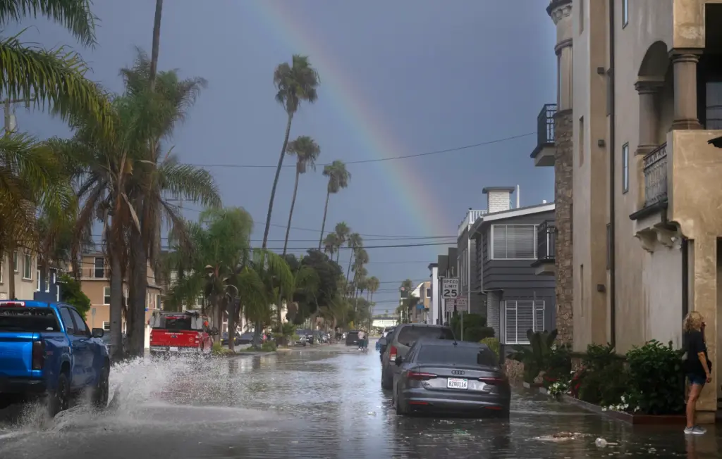 A rainbow spans the horizon of waterlogged Ocean Blvd. in...