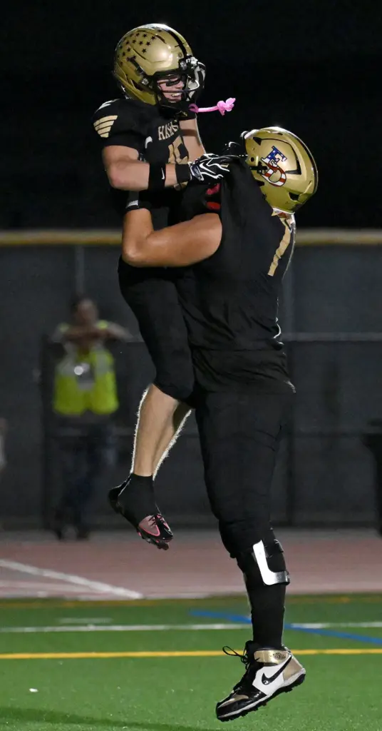 Justin Karg #15 of El Dorado is lifted into the...