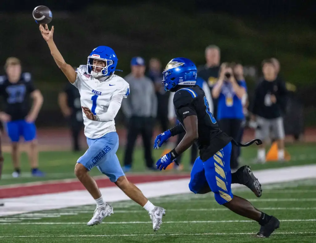 Norco quarterback Julian Medina (1) throws the ball while on...