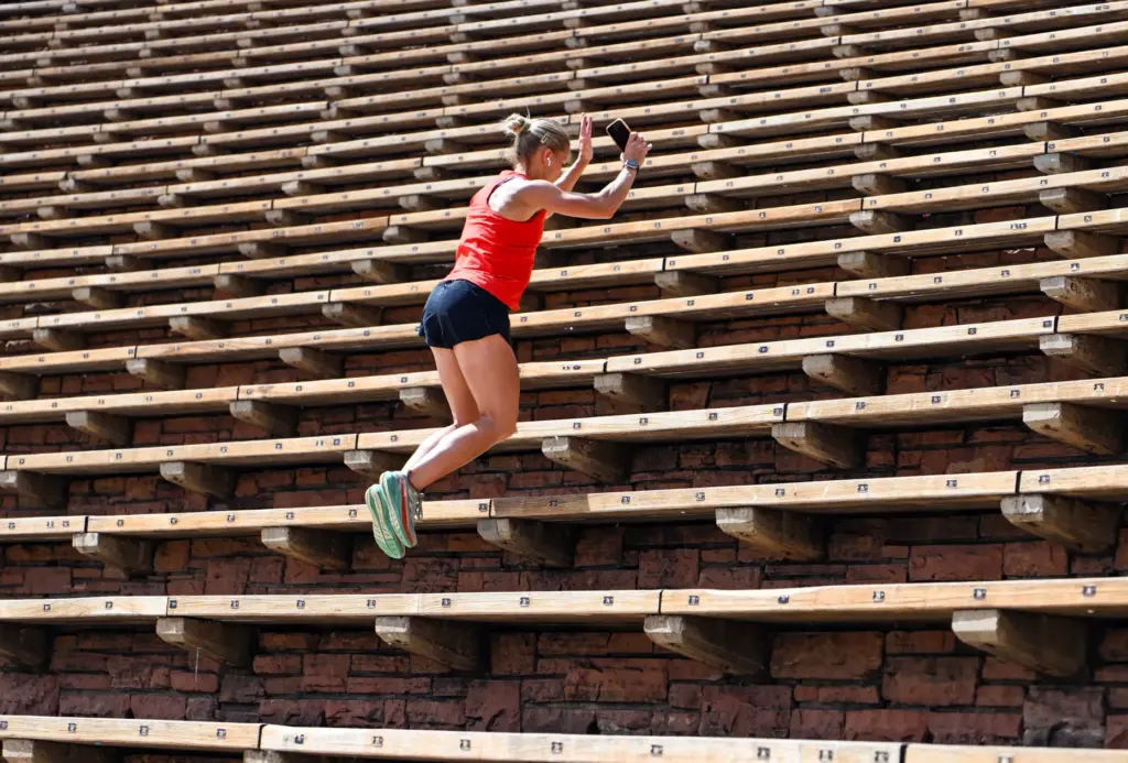 Patsy Lasater jumps up the seats in the amphitheater at...