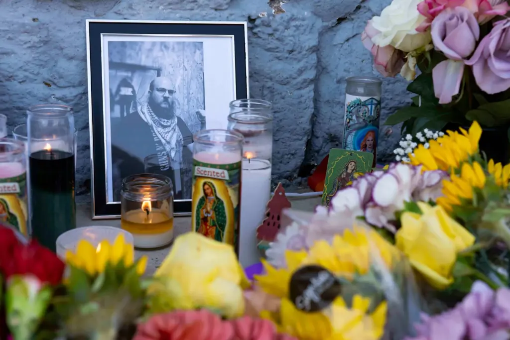 A growing memorial sits outside the Venture-N Bar in Tucson,...