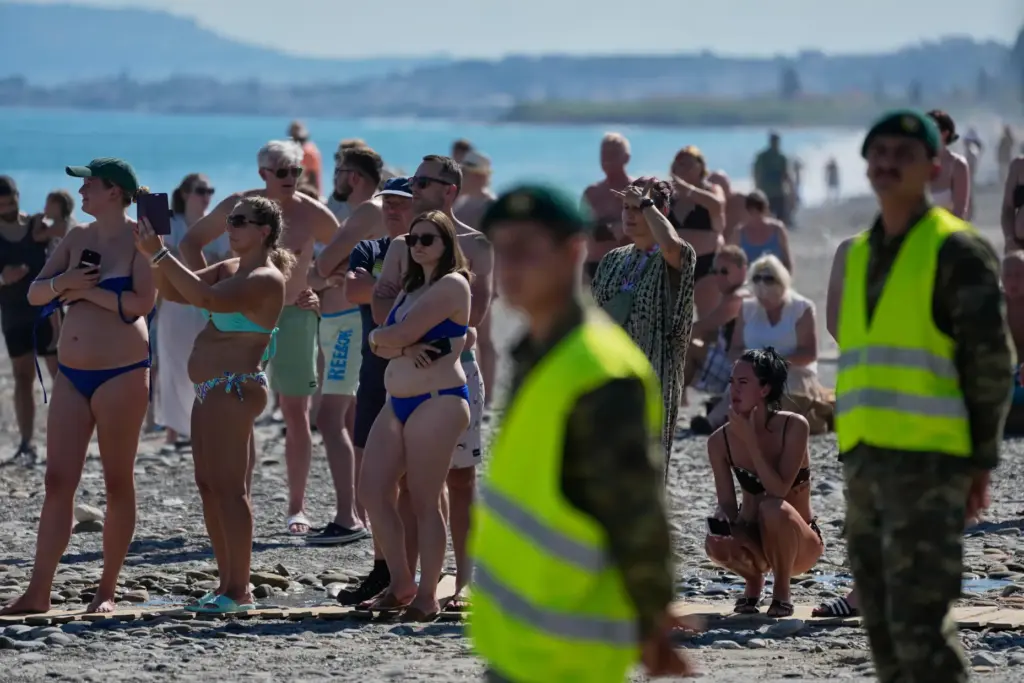 Tourists from nearby hotels watch Medusa 15, a multinational military...